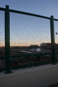 American Fence Company of Omaha - Welded wire mesh on top of a pedestrian bridge